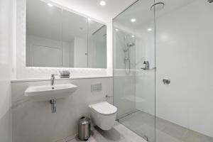 a bathroom with a toilet and a sink and a shower at Bright & Stylish 2-Bedroom Escape in Gordon in Gordon +2 photos