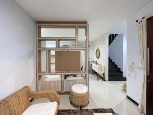 a living room with a couch and a window at Villa Sahadewa Pecatu in Uluwatu
