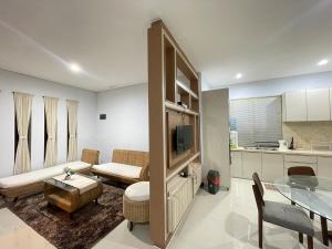a living room with a couch and a table at Villa Sahadewa Pecatu in Uluwatu