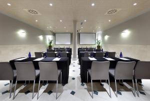 sala konferencyjna ze stołami, krzesłami i parawanami w obiekcie Eurostars Casa de la Lírica w Madrycie