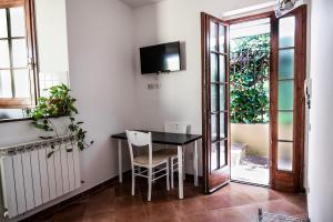 comedor con mesa y TV en la pared en Detached house in a quiet area, close to the Settignano center, en Settignano