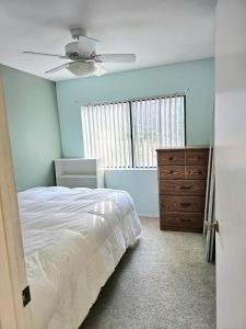 a bedroom with a bed and a ceiling fan at Cat & Coffee Prime City Access - Room 1 in San Diego