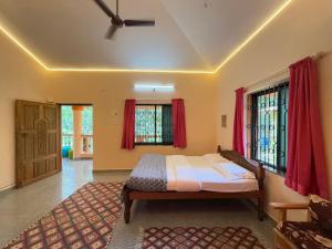 a bedroom with a bed and red curtains at The Studio Parra in Jāmb