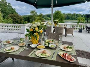 a table with plates of food on a patio at THERESET Schloss Groß Plasten in Groß Plasten