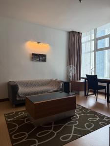 a living room with a bed and a table at Family Suites KL Sentral in Kuala Lumpur