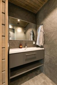 a bathroom with a sink and a mirror at Kinos A Visit Levi in Levi
