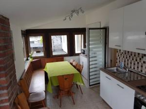 a kitchen with a table with a green table cloth on it at BB Crew House in Stipshausen +8 photos