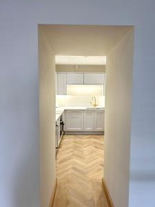 a kitchen with white cabinets and a wooden floor at Luxury Flat in Shaftesbury by JOT STAYS in Shaftesbury +37 photos