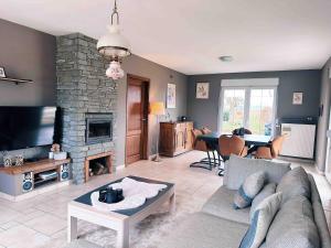 a living room with a couch and a fireplace at Rustic Haven in La-Roche-en-Ardenne