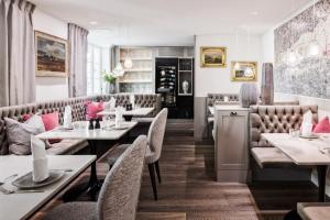 a restaurant with tables and couches and chairs at Das Ludwig in Lindau