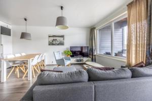 a living room with a couch and a dining room table at Järvenrantahuoneisto LakeVillas B1 in Ukkohalla +11 photos