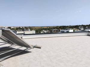 a chair sitting on top of a roof at Villa Paraiso in Alcantarilha