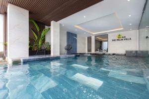 a large swimming pool in a hotel lobby at Villas VIP Trực Diện View Biển GREEN DAY 24 Sang Trọng in Vung Tau