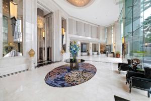a lobby with a table in the middle of a building at Grande Centre Point Hotel Terminal21 in Bangkok