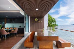 a dining room with a view of the ocean at Villas VIP Trực Diện View Biển GREEN DAY 24 Sang Trọng in Vung Tau