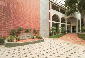 a building with a sign in front of it at Leisure Resort in Pondicherry