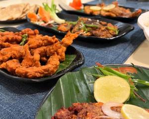 a table with plates of food on a table at Leela beachside stay in Kashid