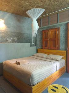 a bedroom with a large bed with a wooden frame at Khao Sok Country Resort in Khao Sok National Park