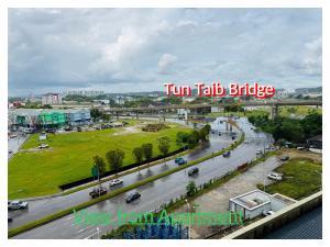 a view of a street with cars on a highway at Bridge Apartment next to The Spring in Bintulu