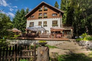 a house with a fence in front of it at Kuker Hut - Хижа Кукер in Sofia