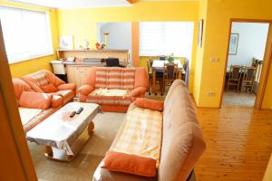 a living room with two couches and a table at Vila Biba - Ilijas in Ilijaš
