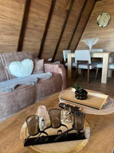 a living room with a table and a couch at Vile NIT in Raška