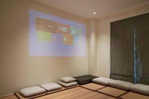 a room with a screen and a bench with pillows at Jades House Sầm Sơn in Sầm Sơn