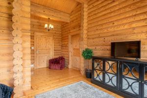 a living room with a flat screen tv in a log cabin at Constable Burton in Constable Burton