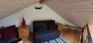 a room with a blue chair in a attic at Refuge de La Coste  +7 photos
