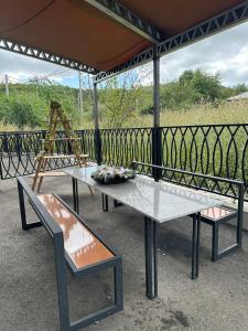 two tables and chairs sitting under a roof at Alvina Terrace in Tsaghkadzor +2 photos