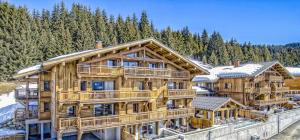 a large wooden house with snow on it at ASAI210-2-2 Appartement 4 étoiles - Les Saisies - 11 personnes in Les Saisies