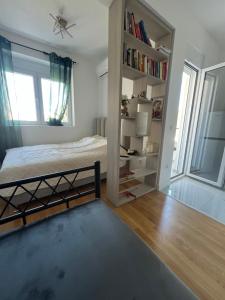 a bedroom with a bed and a book shelf at SunnyBar in Bar