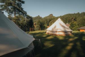 a large tent sitting in the grass in a field at Glamping Natur Resort Jetřichovice in Jetřichovice