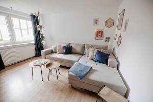 a living room with a couch and a table at Altstadt Apartment Lemgo in Lemgo