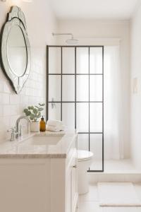 a bathroom with a sink and a toilet and a mirror at Iconic Hollywood Homestay Near Walk Of Fame in Los Angeles