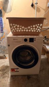 a washing machine with a bowl on top of it at Modern DesignApartment plus Garden 