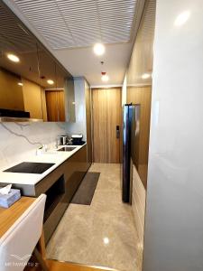 a kitchen with a sink and a refrigerator at Brand New 2 bedroom near Paragon in Pratunam