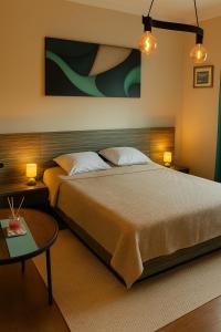 a bedroom with a large bed and a table at Obilic L - City View apartment in Pedestrian Zone in Belgrade +5 photos