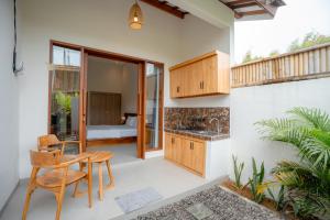 a kitchen and dining area of a house at Abimanyu Guest House in Seminyak