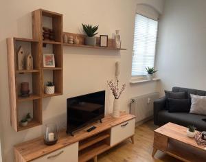 a living room with a tv and a couch at Ferienwohnung - Auszeit - Buchholzer Straße 29 in Annaberg-Buchholz