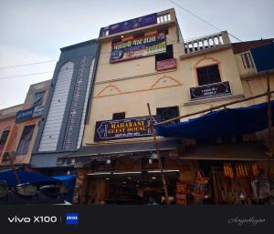 un edificio con dei cartelli sul lato di SPOT ON Maharani guest house a Ayodhya