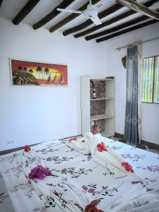 a woman laying on a bed in a bedroom at Sweet Home in Kiwengwa