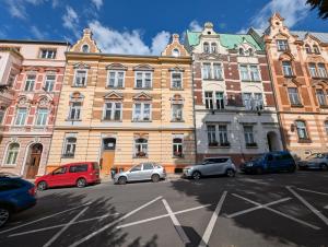 a group of cars parked in front of a large building at U Bílého Beránka in Děčín