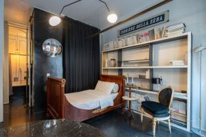 a bedroom with a bed and a desk and a chair at Milano Artist Apartment in Milan