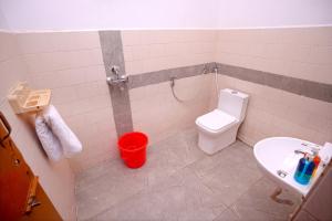 a bathroom with a toilet and a sink at Hotel Film Suites in Hyderabad