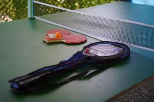 a tennis racket and a pair of shoes on a tennis court at your dream cottage in Ts'ikhisdziri