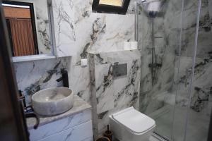 a bathroom with a sink and a shower and a toilet at your dream cottage in Ts'ikhisdziri +14 photos