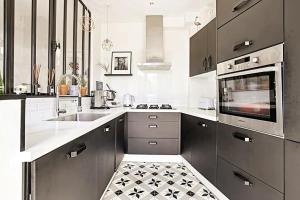 a kitchen with a sink and a stove top oven at Charmante maison de ville aux portes de Paris in Suresnes