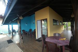 a dining room with a table and chairs on a porch at Soluna Ocean Villa in Tangalle