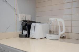 a kitchen counter with a coffee maker and a toaster at 2BR Private Apartment in Al Zahia Sharjah - Wood house in Sharjah